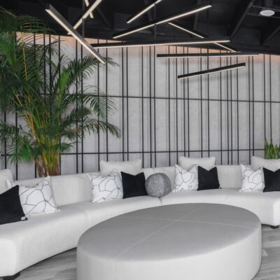 Beyond obsessed with these details. ✨ With a stunning black and white color palette, beyondwellnessoc's lobby features a unique rope wall detail against a concrete backdrop, complemented by all-new black fixtures, custom sign, and playful pillow upholstery. hausofdesign medspa interiordesign details